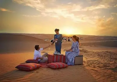 a group of people sitting on the beach at glamping Dunes CAMP in Merzouga