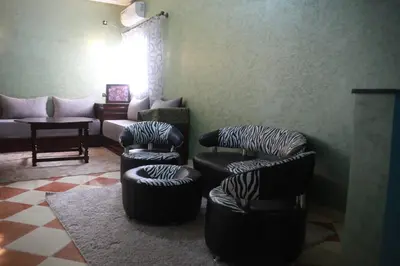a living room with three chairs and a couch at Résidence dikre in Ouarzazate