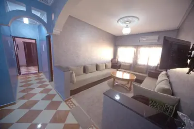 a living room with a couch and a table at Résidence dikre in Ouarzazate