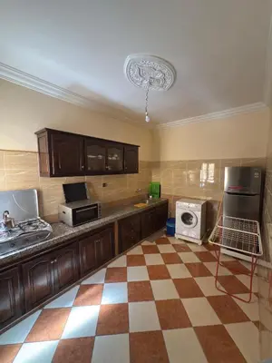a kitchen with a checkered floor at Résidence dikre in Ouarzazate