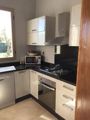 a kitchen with stainless steel appliances and a window at fleur de marrakech in Marrakech