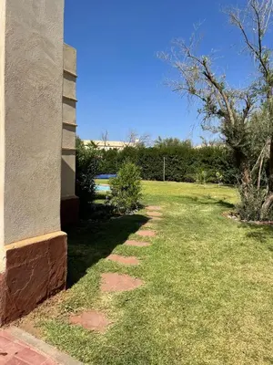 a side view of a house with a grass yard at fleur de marrakech in Marrakech