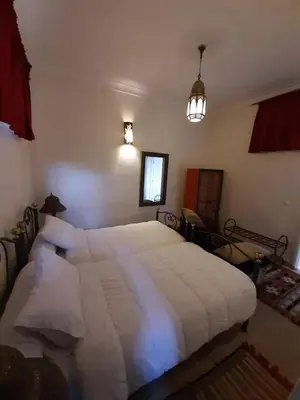 a bedroom with a large white bed in it at Dar Abdesalam in Fès