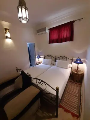 a bedroom with a bed and a red window at Dar Abdesalam in Fès