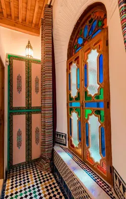 a room with a door and a tiled floor at Riad Fes Nass Zmane in Fès