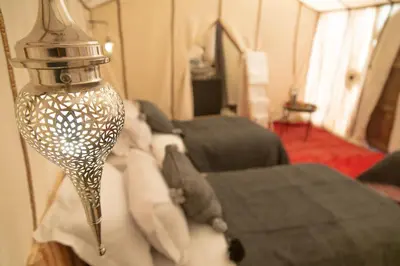 a lamp hanging over a couch in a living room at Tiziri Camp in Merzouga