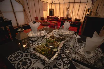 a table with a plate of food on it at Tiziri Camp in Merzouga