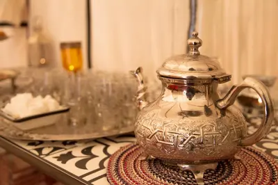 a silver tea pot sitting on a table at Tiziri Camp in Merzouga