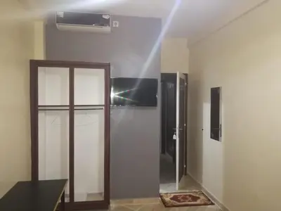 a room with a glass door and a mirror at Gite porte oasis in Er Rachidia