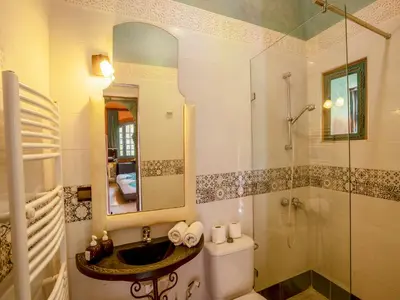 a bathroom with a toilet and a sink and a shower at Riad Clé De Sol & SPA in Aghmat