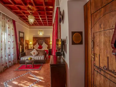 a living room with a couch and a table at Riad Clé De Sol & SPA in Aghmat