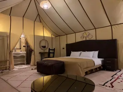 a bedroom with a bed in a tent at Erg Chebbi in Merzouga