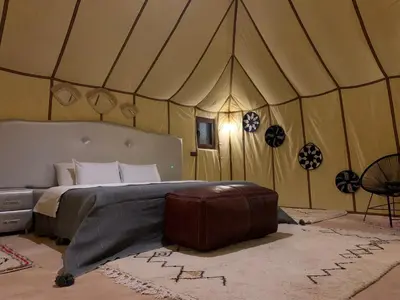 a bedroom with a bed in a tent at Erg Chebbi in Merzouga