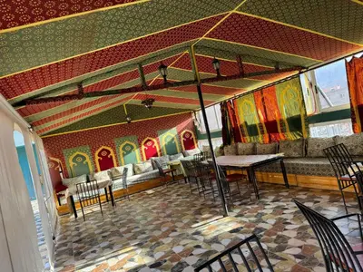 a dining room with a table and chairs at AUBERGE ROYAL PALMAS in Tinerhir