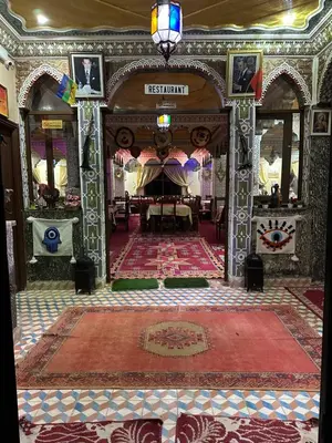 a large room with a table and a rug on a floor at AUBERGE ROYAL PALMAS in Tinerhir