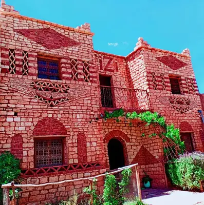 a red brick building with a staircase in it at Tizi Maison d'Hôtes in Telouet