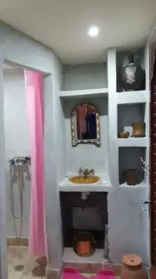 a bathroom with a sink and a mirror at Tizi Maison d'Hôtes in Telouet