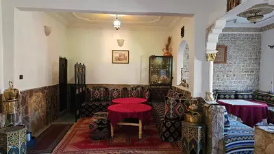 a room with a table with a red table cloth at Tizi Maison d'Hôtes in Telouet
