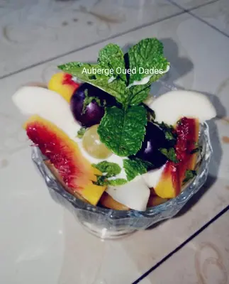 a salad in a glass bowl with fruit and mint at Auberge oued dades in Boumalne