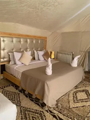 a bedroom with a large bed in a tent at Comfort Luxury Camp in Merzouga