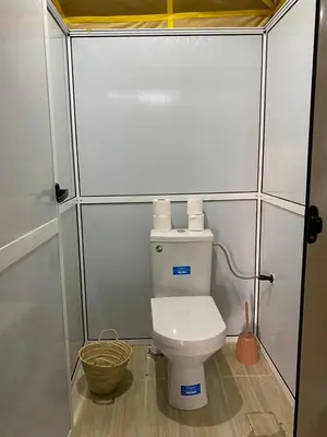 a small bathroom with a toilet in a stall at Comfort Luxury Camp in Merzouga