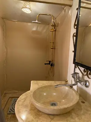 a bathroom with a sink and a mirror at Comfort Luxury Camp in Merzouga