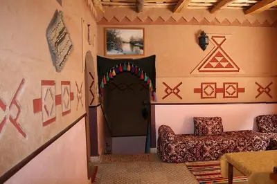 a room with a room with a door and a chair at Riad Atlas Berbère in Boumalne