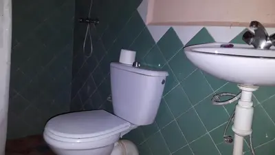 a bathroom with a toilet and a sink at Riad Atlas Berbère in Boumalne