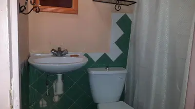 a bathroom with a sink and a toilet at Riad Atlas Berbère in Boumalne