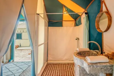 a bathroom with a shower in a tent at Sahara Magic Camp in Merzouga