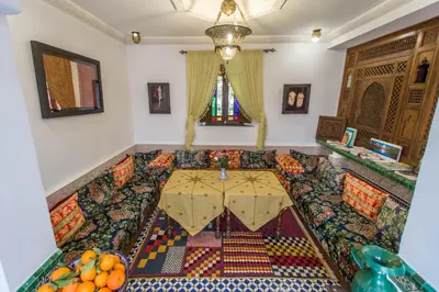 a living room with a couch with an umbrella at Dar Fes Medina Ziat in Fès
