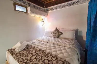 a bedroom with a bed in a room at Dar Meknes Tresor in Meknès