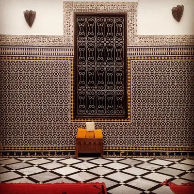 a room with a black and white tiled wall at Riad Tizwa Fes in Fès