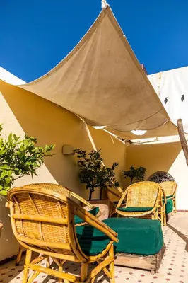 a group of wicker chairs and a tent at Riad Tizwa Fes in Fès