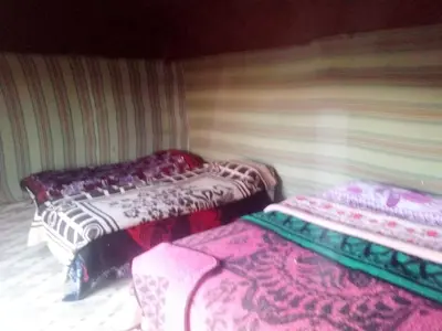 a room with two beds in a room at Camel Trek Bivouac in Merzouga