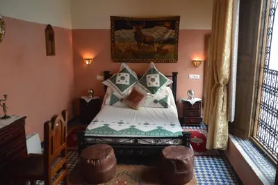 a bedroom with a bed in a room at Riad Oumkaltoum Fès in Fès
