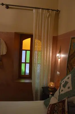 a bedroom with a bed and a window at Riad Oumkaltoum Fès in Fès