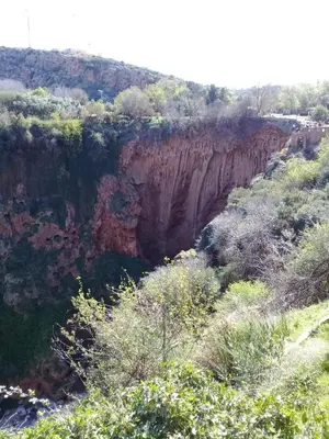 a view of a canyon with trees and rocks at Auberge Restaurant Les Coquelicots in Aït Tamellil