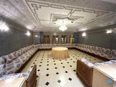 a large room with a table and chairs in it at Hôtel Plaisance in Meknès