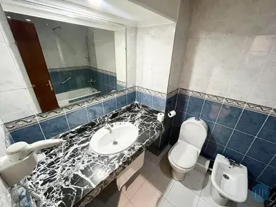 a bathroom with a sink and a toilet and a mirror at Hôtel Plaisance in Meknès
