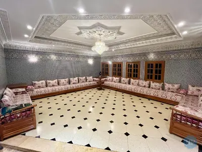 a large room with pink furniture and a ceiling at Hôtel Plaisance in Meknès