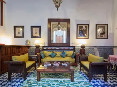 a living room with two couches and a coffee table at Dar Roumana in Fès