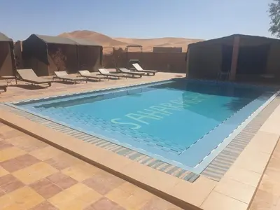 a swimming pool in the middle of the desert at Auberge Sahara Garden in Lac Yasmins