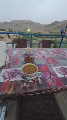 a table with a cup of coffee and plates of food at Auberge Jbel Raids in Tagoudit