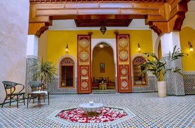 a courtyard with a fountain in the middle of a building at Riad Zidania in Meknès