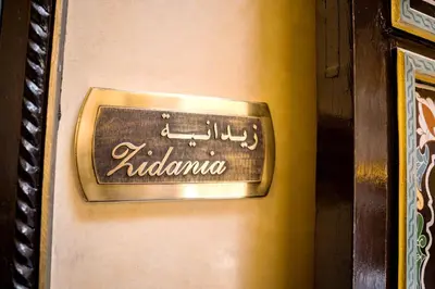 a metal sign on a door with the word ritzulum at Riad Zidania in Meknès