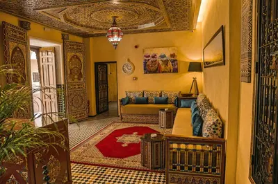 a living room with a couch and a rug at Riad Zidania in Meknès