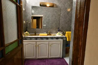 a bathroom with a sink and a mirror at Riad AlKATIB Meknès in Meknès