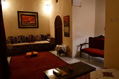a living room with a couch and a chair at Riad AlKATIB Meknès in Meknès