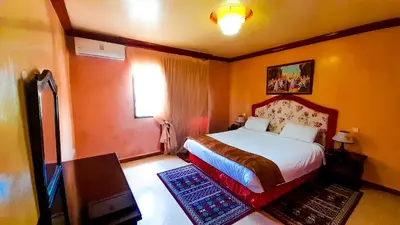 a bedroom with a large bed and a window at Hôtel Relais Saiss in Sefrou